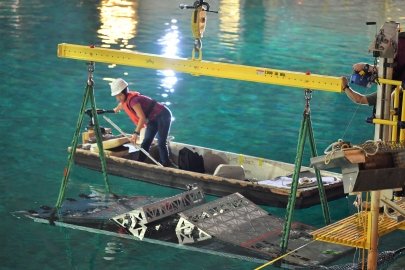Worker above a wave tank. 