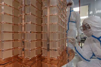 A research scientist examines the CUORE detector, an array of a thousand crystals made of a special material that is designed for rare event searches. CUORE is located 4,500 feet underground at the Gran Sasso National Laboratory in Italy. 