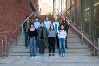 Two rows of students standing on an outdoor staircase.