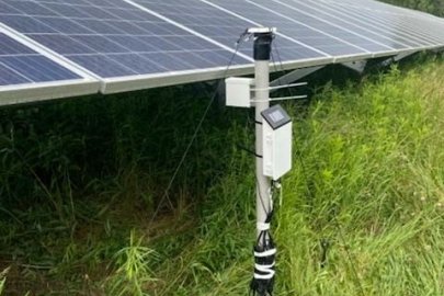 Field testing equipment monitors underground soil moisture at a New York solar facility.
