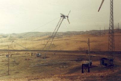 A wind turbine being installed with other turbines standing nearby.