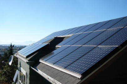 Solar panels on a roof with blue sky above