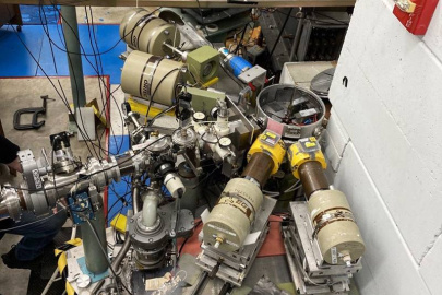 Photo of the experimental setup showing four high-purity germanium detectors surrounding the target chamber at the end of the Triangle Universities Nuclear Laboratory beamline.