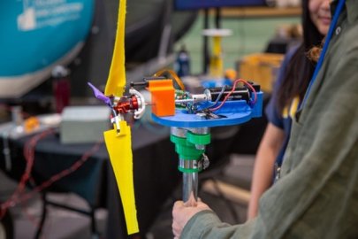 Students work on a wind turbine model. 
