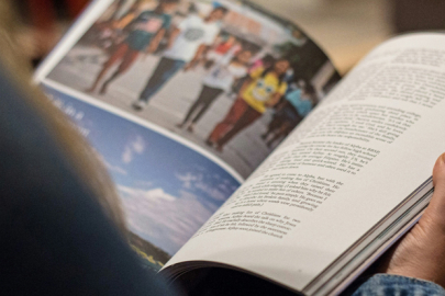 A person looking at a printed magazine
