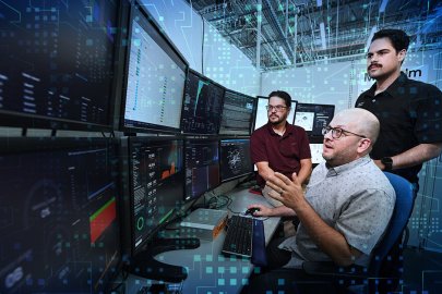 People in front of a computer with technology-themed images overlaid 
