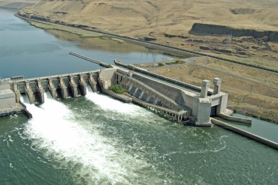 A hydropower facility, with mountains in the distance