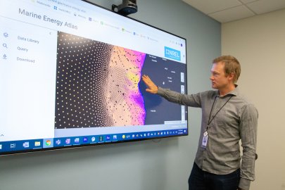 A man uses a touchscreen to show a model