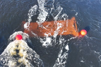 A marine power system being deployed in the water