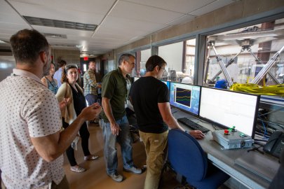 People standing in a control room 