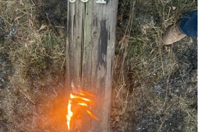 wooden pole on fire at base