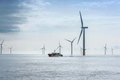 ocean-bound turbines near boat. 