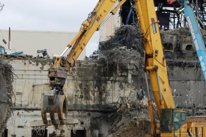Large, yellow, construction machinery removing materials 