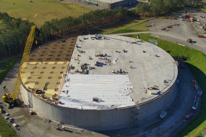 An aerial video of a large circular facility building