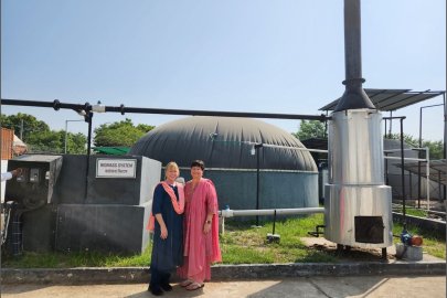 Merrill Smith (left) and Noel Schulz at the Harnoo Village Biomass System.