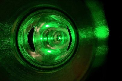 The Compton polarimeter’s laser system, used to measure electrons’ parallel spin, is aligned during the Calcium Radius Experiment in Hall A of the Continuous Electron Beam Accelerator Facility at the Thomas Jefferson National Accelerator Facility.