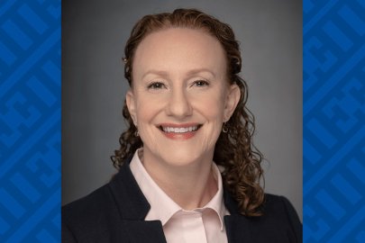 Portrait of a smiling woman dressed formally.