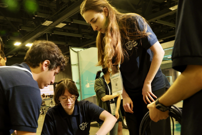 Four Collegiate Wind Competition participants working on their team’s turbine.