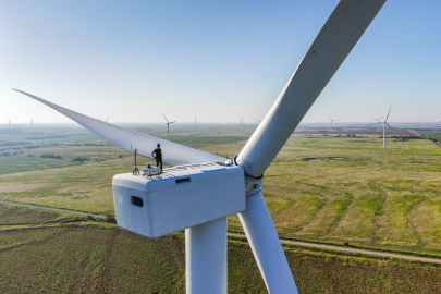 A researcher on top of a wind turbine.