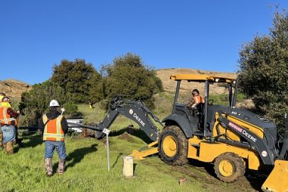 U.S. Department of Energy contractors provide oversight of trenching activities.