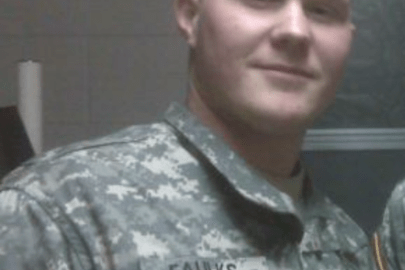 A person in a military uniform looking at the camera. 