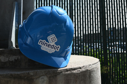 Blue helmet with the Ninedot Energy logo resting on a post