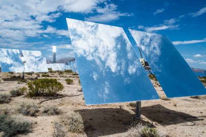 Heliostat mirror reflects sky and clouds