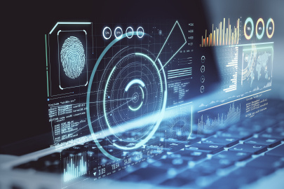 Computer screen of charts and graphs above a keyboard