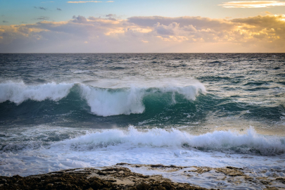 A wave crashes on a beach