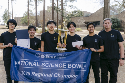 A group of students pose for a picture after winning a science bowl competition