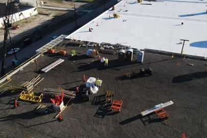 Workers use two layers of thick materials to cover the existing roof of the X-330 Process Building at the Portsmouth Site.