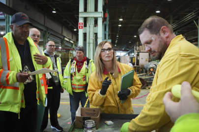 A group of employees in safety gear participate in a training