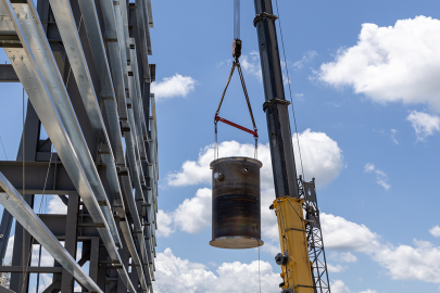 Engineering Test Unit 3.0 reactor vessel being carried by a crane.