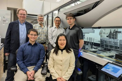 The CABBI team in the iBioFAB biofoundry at the Carl R. Woese Institute for Genomic Biology (IGB). Front row, researchers Seth Croslow and Jia Dong. Back row, from L: PIs Mathew Hudson, Jonathan Sweedler, Huimin Zhao, and Biofoundry Manager Stephan Lane