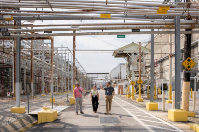 Three employees walking outside of facility buildings at the Savannah River Site