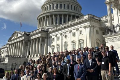 A large group of people posing for a photo on the steps of the U.S. Capitol Building