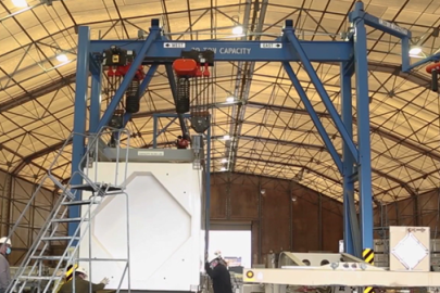 A large blue piece on equipment inside a facility building