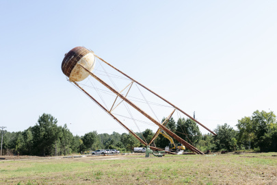 A large water tower being demolished
