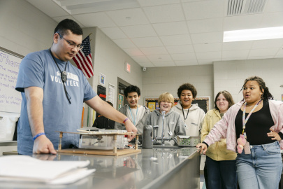 A group of students participating in a STEM experiment in a lab