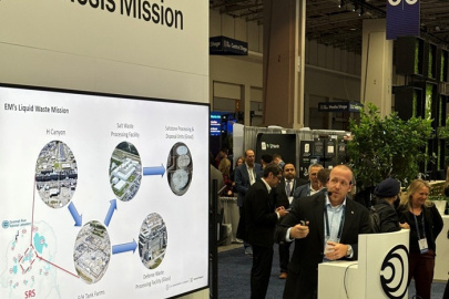 A professional giving a presentation at an Expo on the DOE Genesis Mission