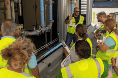 Rotating set of images of a group of teachers wearing yellow safety vests touring the Paducah Site with employees