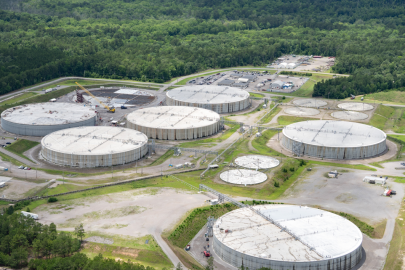 Aerial view of six large circular facility buildings at the Savannah River Site with trees surrounding