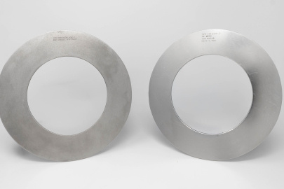 Two circular metal rings on a light grey background