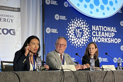 Panelists sitting on stage at a conference participating in a discussion