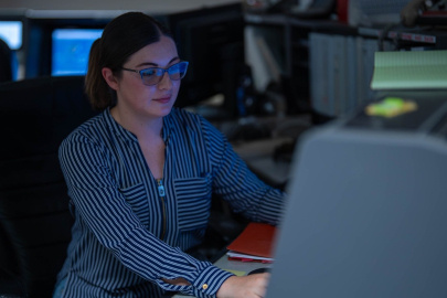 A woman sitting at a desk working on a computer