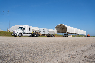 A large white truck with two white tanks on the back 