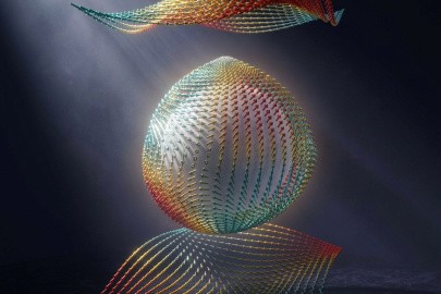 Illustration of an antivortex polaron in a zinc-blende crystal. An electron twists nearby atoms and the distortion spreads through the lattice via coupling between electrons and phonons.