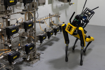 A robotic dog walking around in a laboratory 