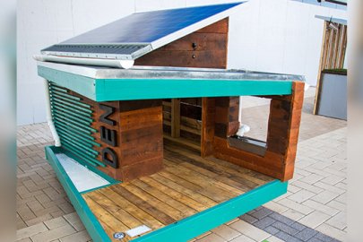 A solar powered dog house on display.