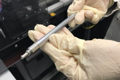 Picture of hands holding a test fuel pin designed by Framatome.